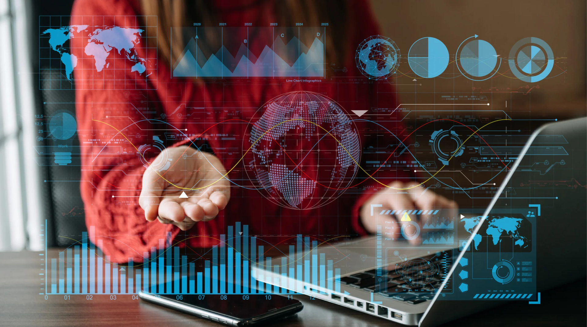 Person in front of a laptop with charts, maps and digital data overlays
