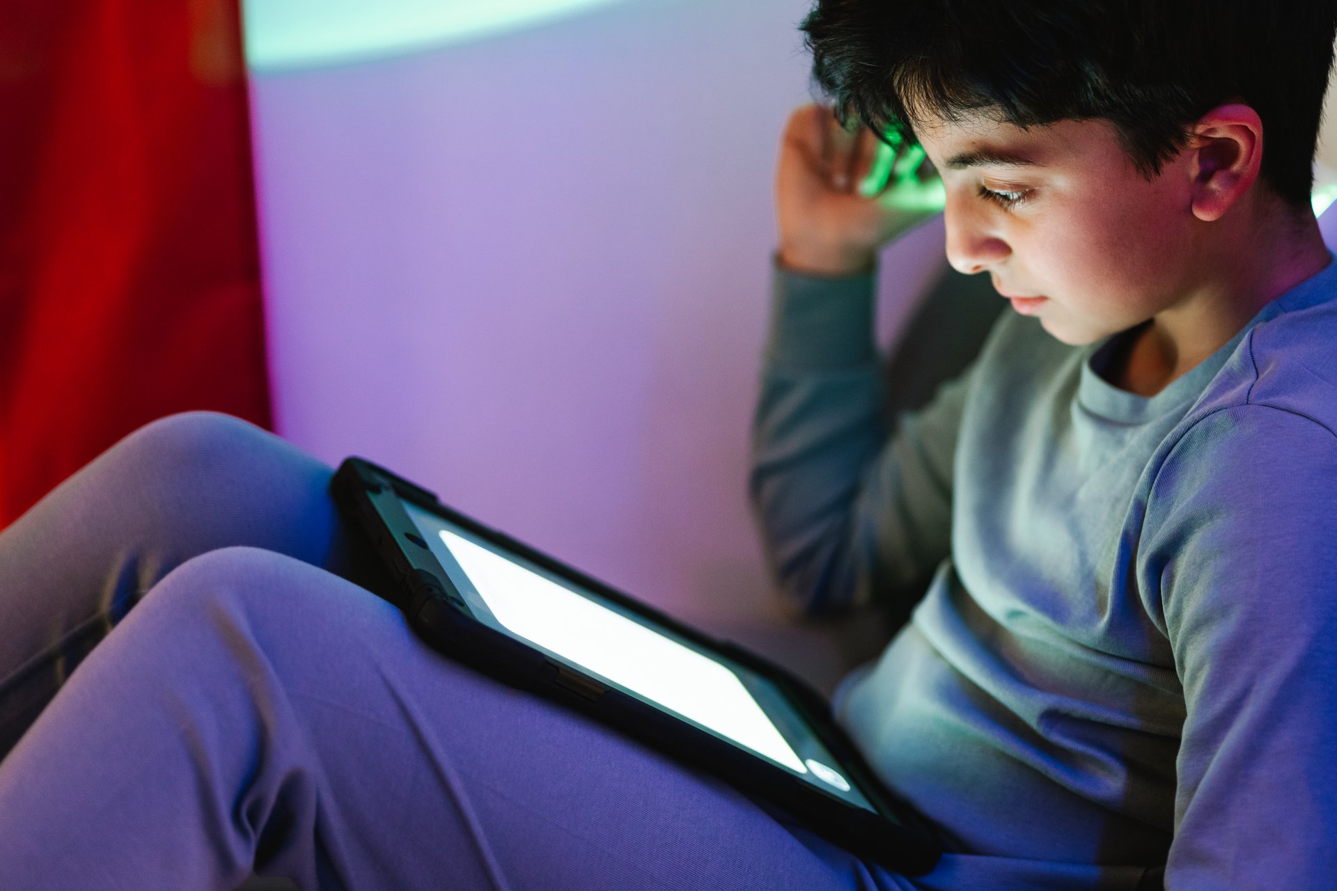 Teen watching content on a tablet at home